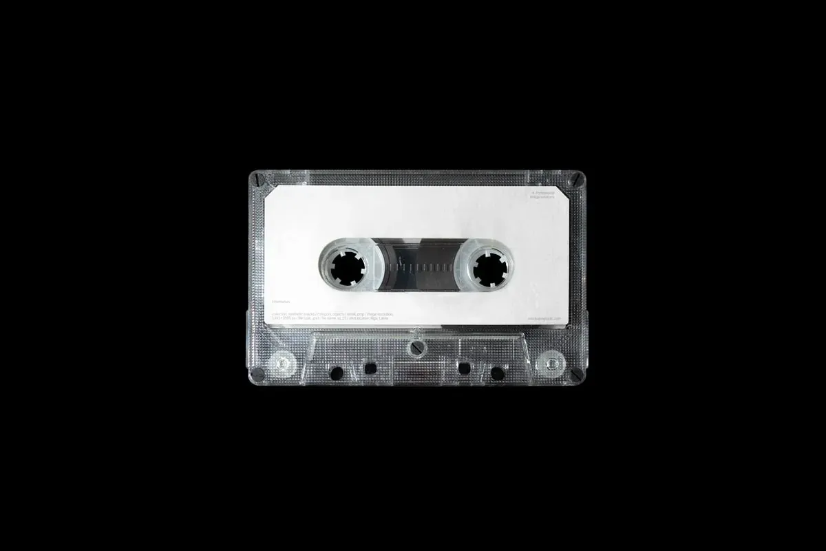 A clear cassette tape on a black background
